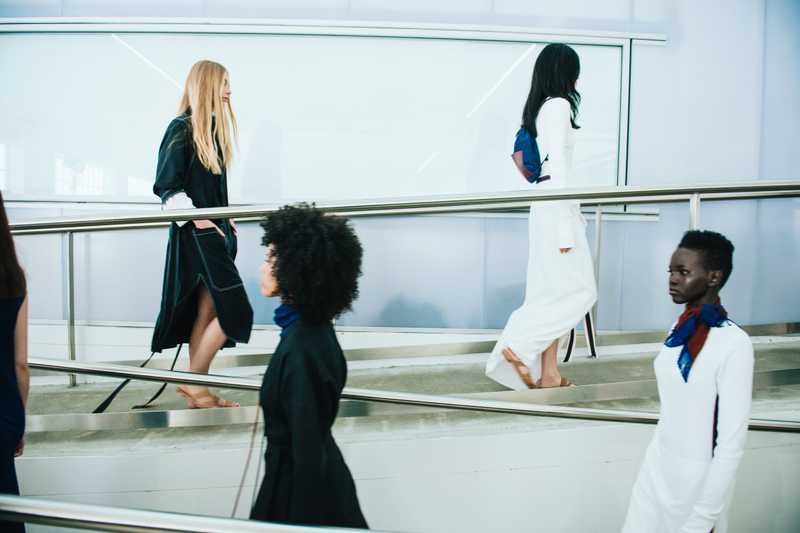 Models wearing black and white on a zig zag runway.
