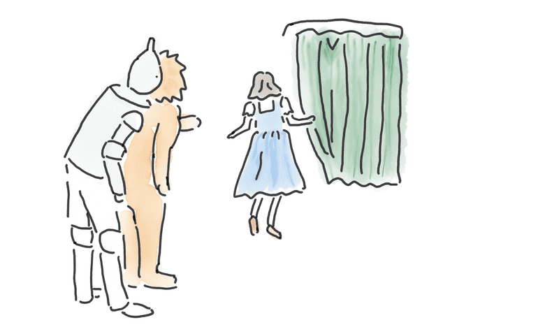 Dorothy, the lion, and the tin man approaching a curtain